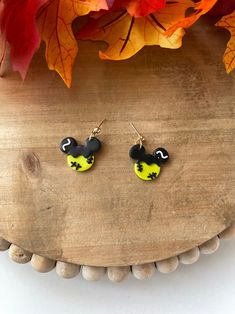 the mickey mouse earrings are yellow and black