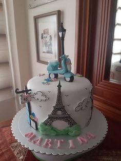 a birthday cake decorated with the eiffel tower