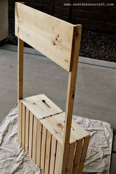 a wooden chair sitting on top of a white sheet