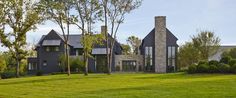 a large house sitting on top of a lush green field