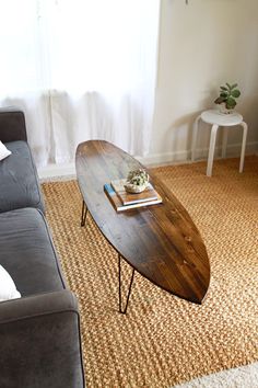 a coffee table sitting on top of a couch in a living room next to a window