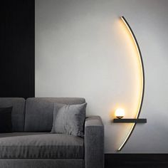 a couch sitting next to a wall with a light on it