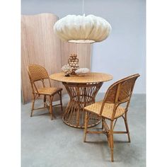 a table with chairs and a lamp hanging from the ceiling