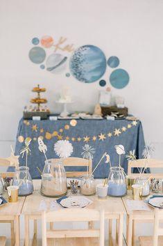 a table topped with vases filled with sand and sea animals on top of it