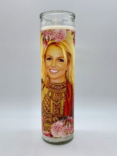 a candle with a painting of a woman on it