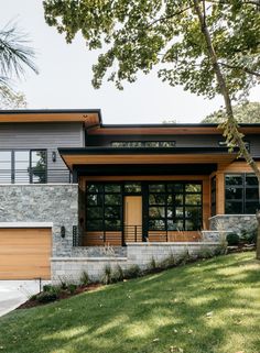 a modern house with stone and wood accents