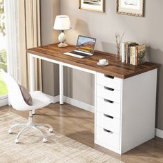 a white desk with drawers and a laptop on it