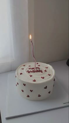 a birthday cake with a single candle on it