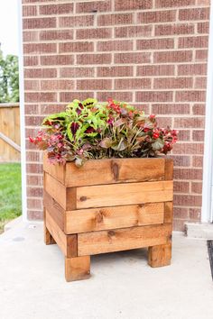 a wooden planter with plants in it