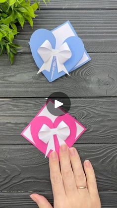 someone is making origami hearts out of paper