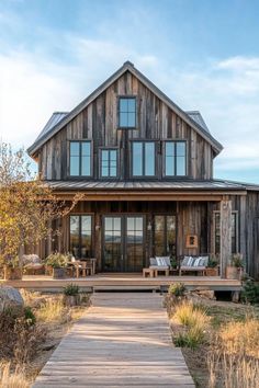 a large wooden house sitting on top of a lush green field