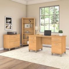 a computer desk sitting on top of a hard wood floor next to a book shelf