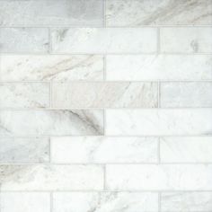 a white marble tile wall that looks like it has been made out of different types of tiles