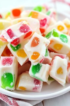 a white plate topped with gummy bears on top of a table