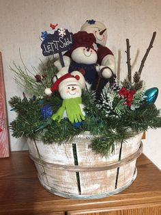 a basket filled with stuffed animals sitting on top of a wooden table