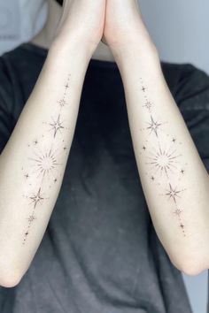 a person with their arms crossed in front of her face and two stars on the arm