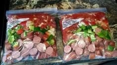 two bags filled with meat and vegetables on top of a counter