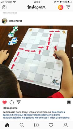 two children are playing a board game on the twitter account, and one is pointing at it