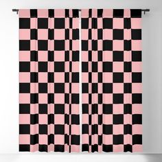 a pink and black checkered curtain hanging on a wall