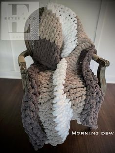 a crocheted blanket sitting on top of a wooden chair