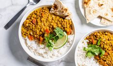 two bowls filled with beans and rice next to tortillas on a white table