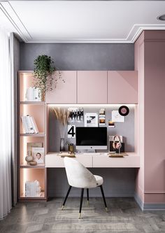 a desk with a computer on it in a pink and grey office space that is decorated with bookshelves