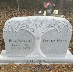 a headstone with a tree on it