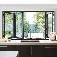 a kitchen with an open sliding glass door leading to the outside patio and pool area