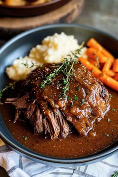 a plate with meat, mashed potatoes and carrots