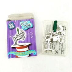 a package of silver plated metal charms with an image of a cat in a hat