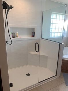 a bathroom with a walk in shower next to a sink