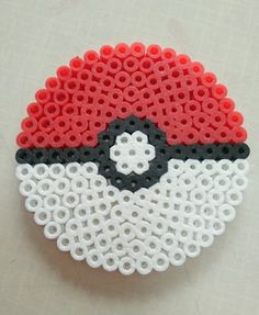 a close up of an object made out of legos on a white surface with red and black circles