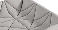 an upholstered grey leather chair with diamond shaped design on the seat and back