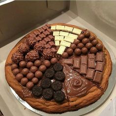 a cake with chocolates, marshmallows and other candies on it