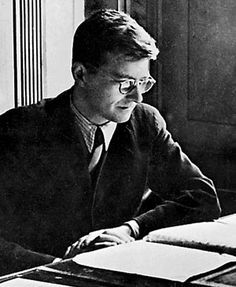 a man sitting at a desk in front of a book