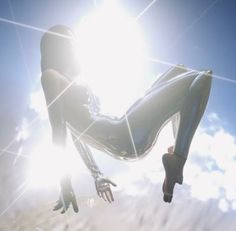 a woman is floating in the air with her legs spread out and hands extended up