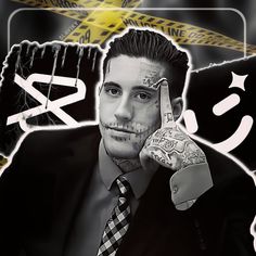 a man in a suit and tie with tattoos on his face holding up the peace sign