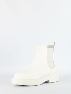 Step out in style with these exquisite white leather Chelsea boots. The matte finish adds a touch of sophistication, while the side elastic bands and back tie provide both comfort and a trendy look. With a 4cm height, these boots are perfect for any occasion, whether it's a casual day out or a special evening event. Made in the UK, these Chelsea boots are a symbol of quality craftsmanship and timeless elegance. White Leather Chelsea Boots With Round Toe, Modern White Boots With Lug Sole, Modern White Leather Boots, White Leather Chelsea Ankle Boots, Chic White Leather Platform Boots, Modern White Platform Boots With Round Toe, Chic White Leather Boots, Modern White Boots For Fall, Modern White Fall Boots