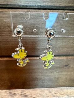 Delight in whimsical charm with Snoopy's Woodstock Bird Friend Dangle Earrings. These adorable earrings feature the lovable Woodstock, capturing a joyful and playful essence. Crafted with attention to detail, these earrings showcase a delightful design that is sure to bring a smile to your face. The dangle style adds movement and flair, making them a fun accessory to wear for any occasion. Whether you are a fan of Peanuts or simply love unique jewelry pieces, these earrings are a must-have addition to your collection. Embrace a touch of nostalgia and fun with these charming Snoopy's Woodstock Bird Friend Dangle Earrings. Snoopy Earrings, Woodstock Bird, Peanuts Cartoon, Snoopy Woodstock, Cute Bird, Bird Earrings, Earrings Cute, Snoopy And Woodstock, Cute Birds