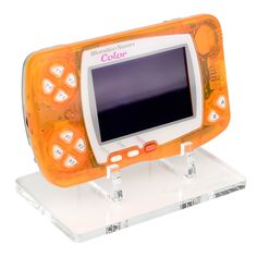 an orange and white electronic device sitting on top of a plastic stand with clear acrylic