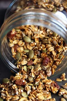 a glass jar filled with granola on top of a table