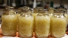 four jars filled with rice sitting on top of a table