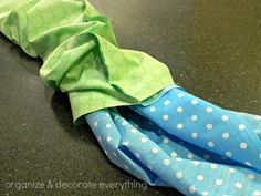 an umbrella is laying on the floor with polka dot fabric and green material around it