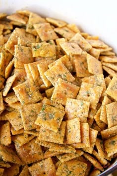 a bowl filled with cheesy crackers sitting on top of a table