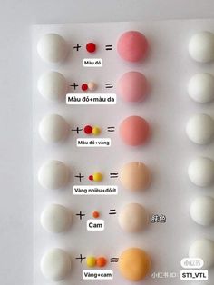 an assortment of different colored balls on a white surface with words written in chinese and english