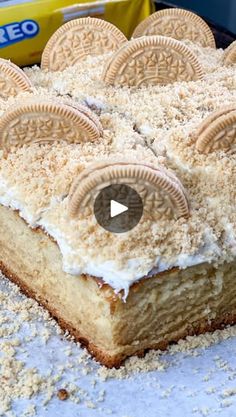 an oreo cookie cake with white frosting and cookies on top, surrounded by powdered sugar