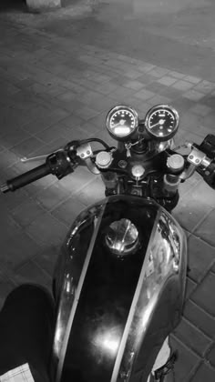 black and white photograph of the handlebars on a motorcycle