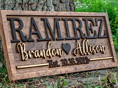 a wooden sign that says ramrez and brandon allisson is shown in front of a tree