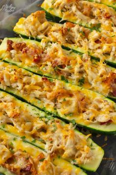 zucchini stuffed with chicken and cheese on a baking sheet