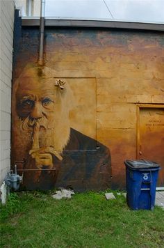 an old man is painted on the side of a building